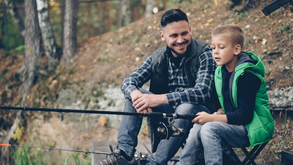 Dad and Son Fishing Outside Together Family