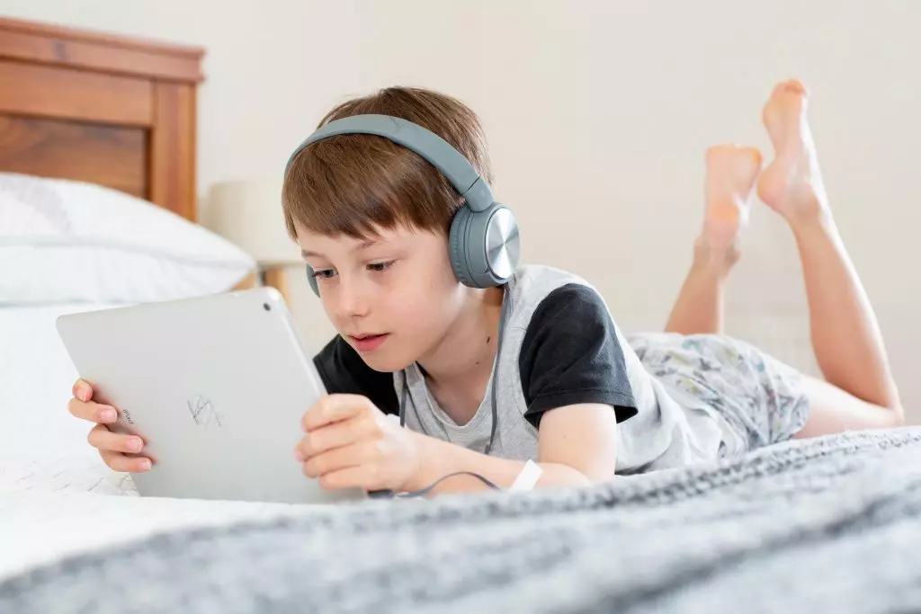 child on tablet screen at home